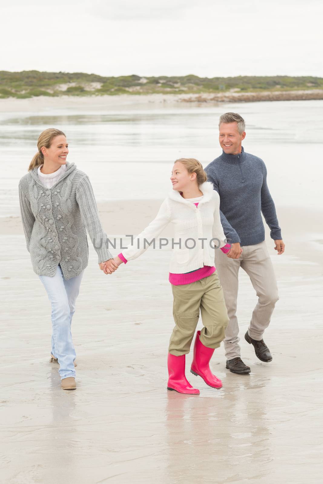 Family casually walking together at the beach