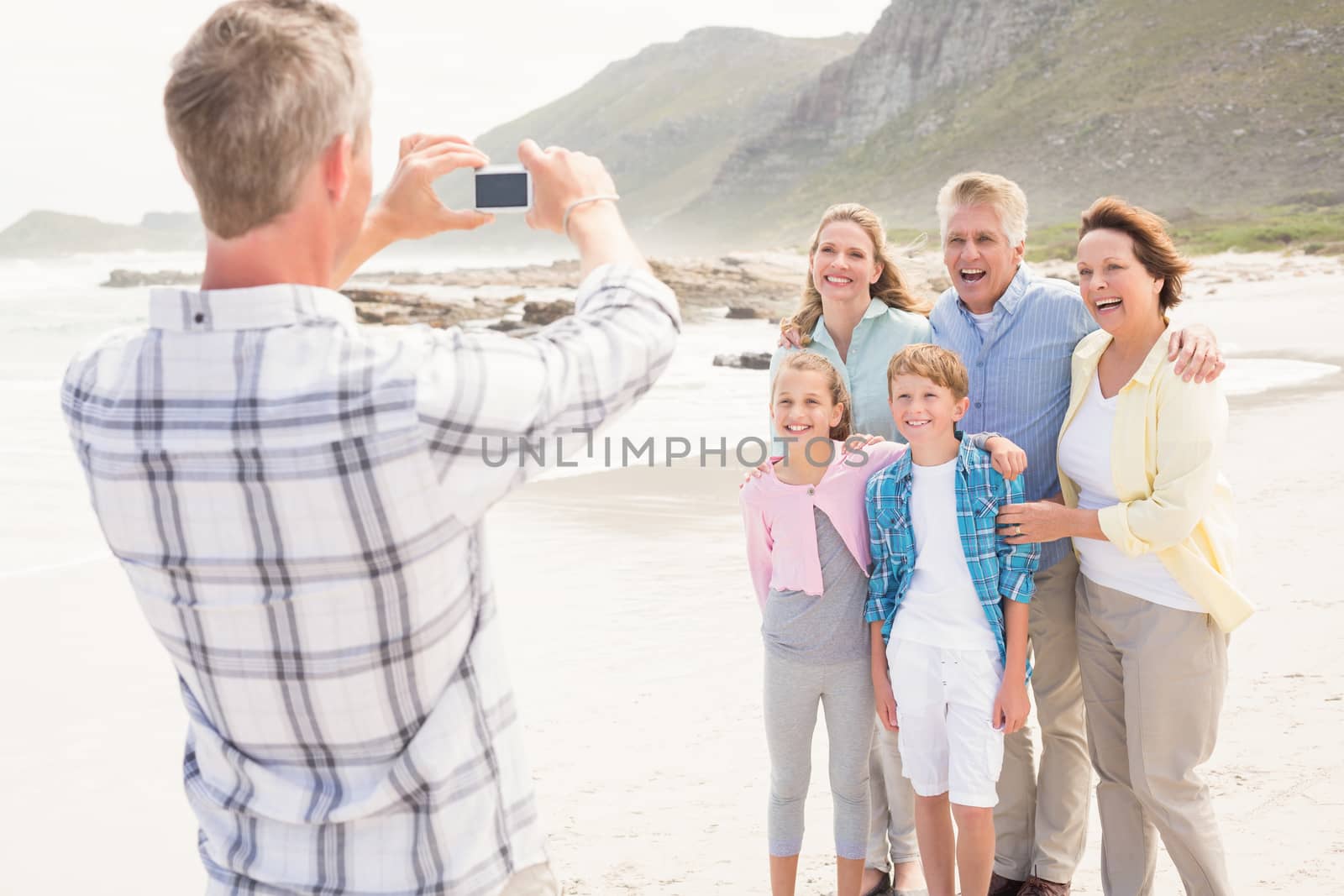 Multi generation family taking a picture at the beach