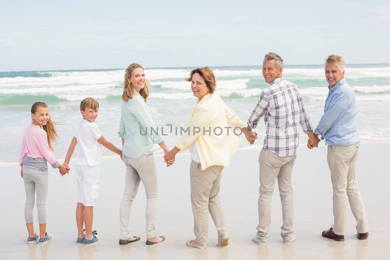 Multi generation family standing beside one another by Wavebreakmedia