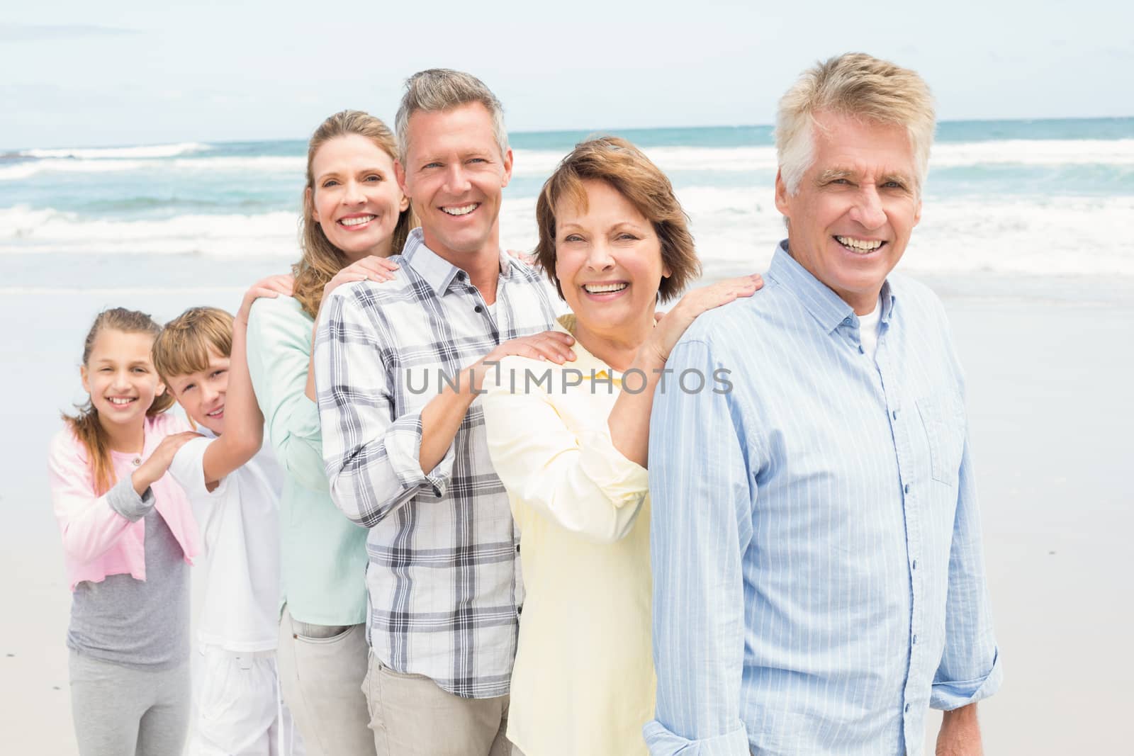 Multi generation family standing beside one another by Wavebreakmedia