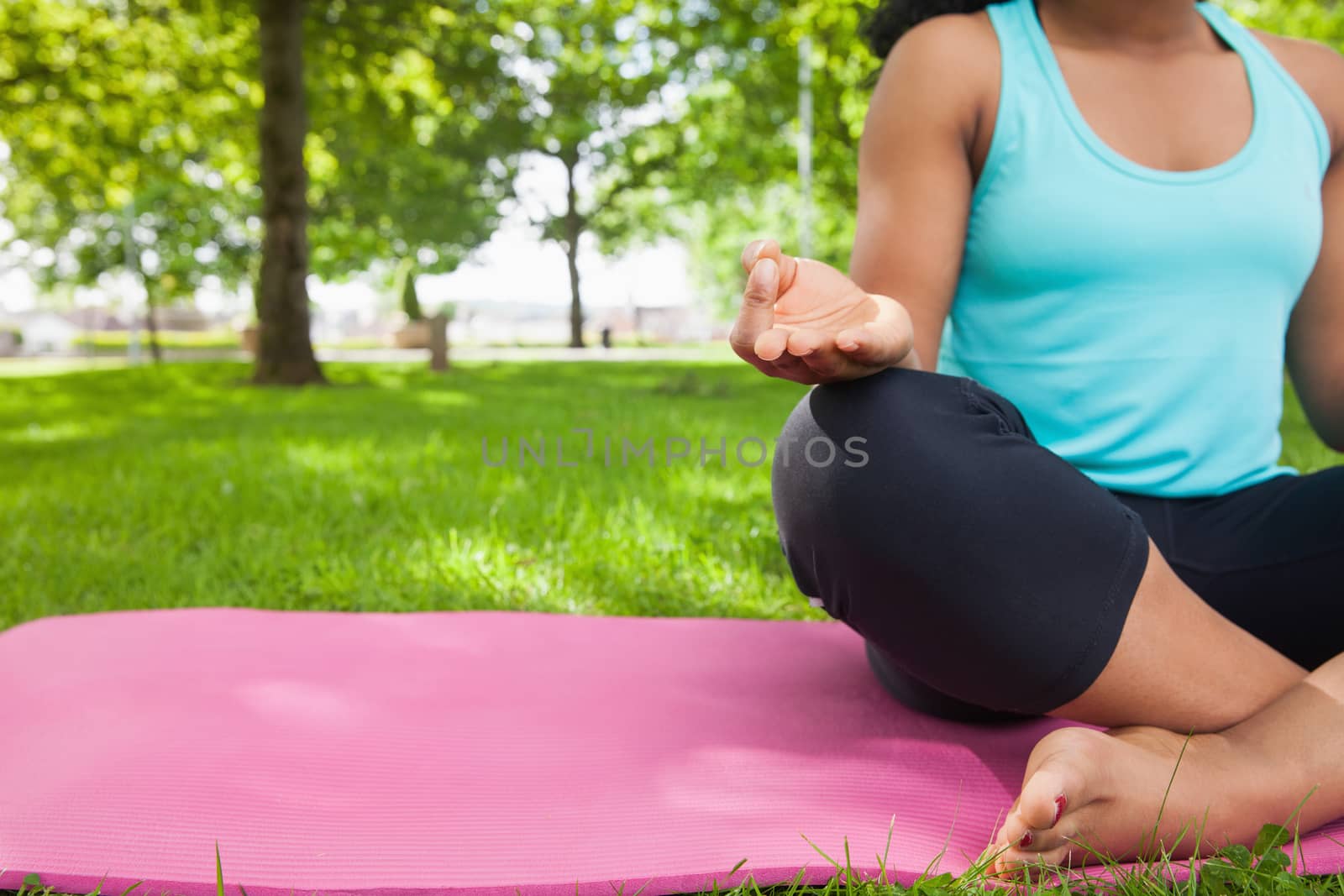 Young woman doing yoga on mat by Wavebreakmedia