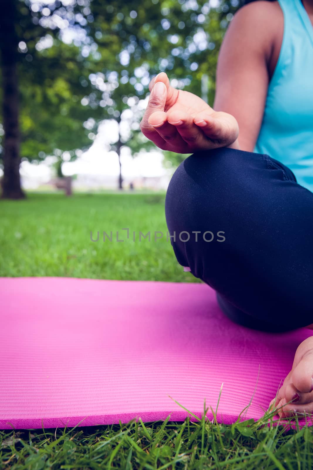 Young woman doing yoga on mat by Wavebreakmedia