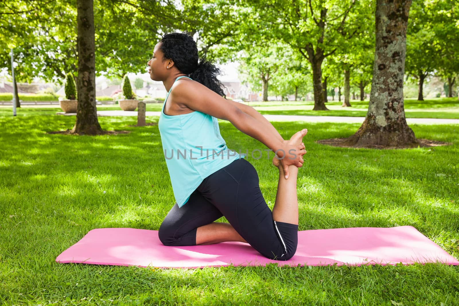Young woman doing yoga on mat by Wavebreakmedia