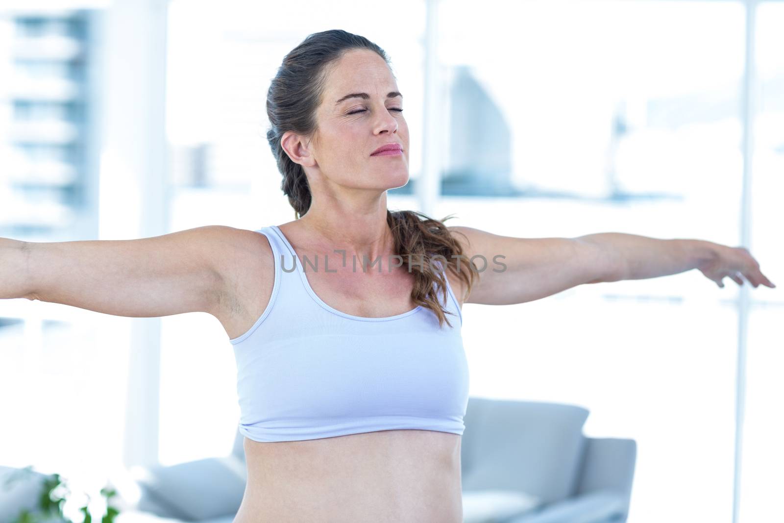 Pregnant woman performing yoga  by Wavebreakmedia