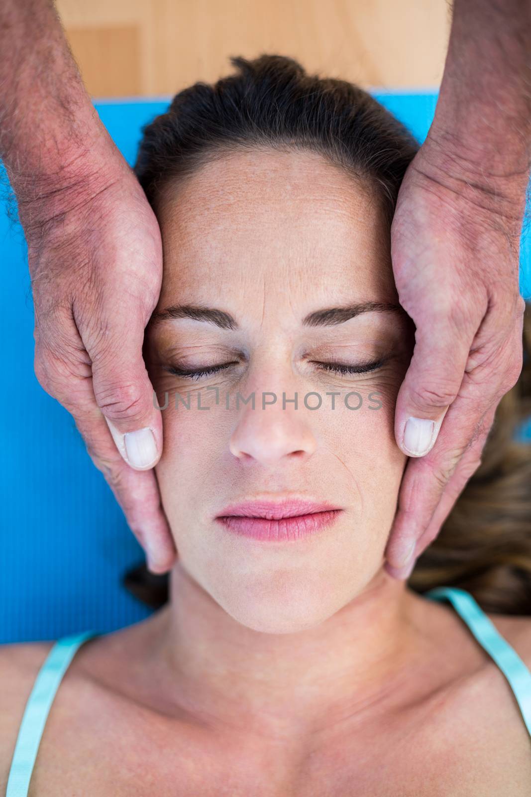 High angle view of therapist performing reiki  by Wavebreakmedia