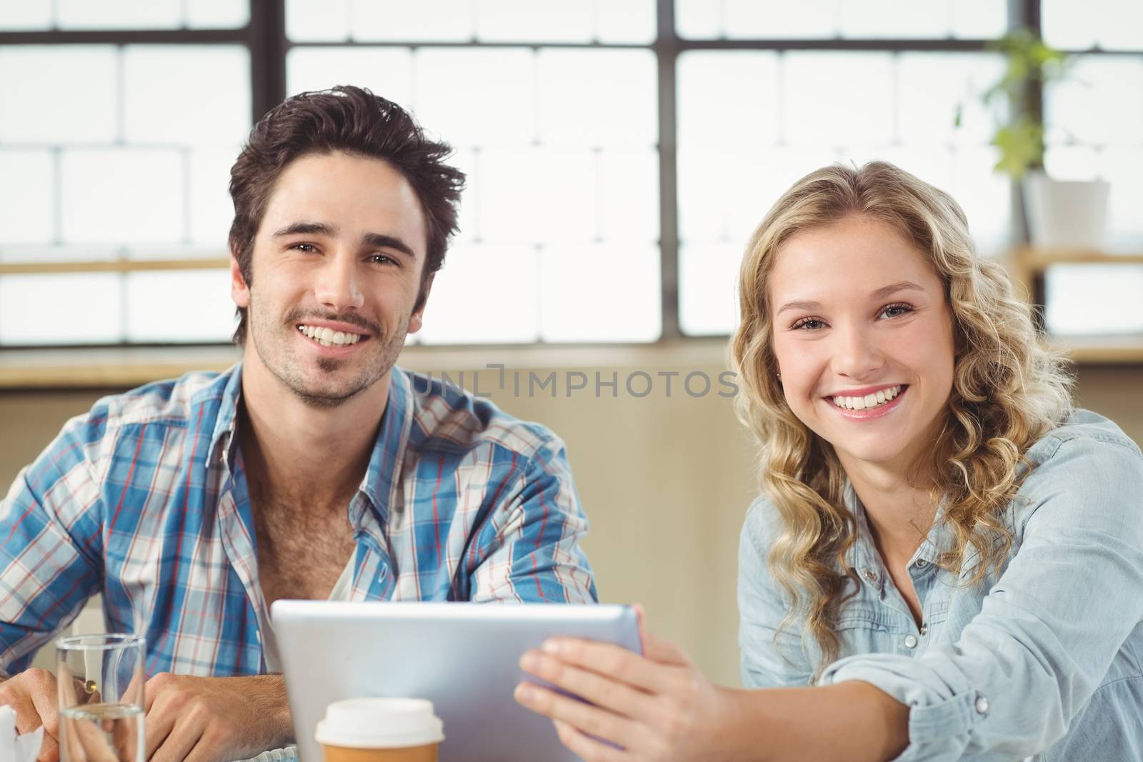 Portrait of business people smiling while working at office  