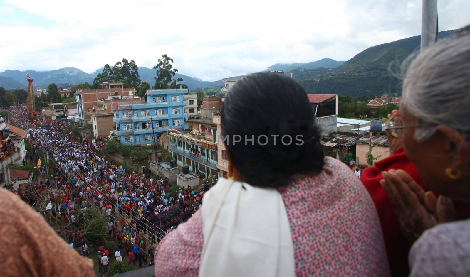 NEPAL, Patan: Nepalese women look on during the festival of rain god Rato Machindranath in Patan, Nepal on September 22, 2015. The festival takes place each April, but was delayed this year after a devastating earthquake damaged the chariot that devotees pull through the area in the hope of securing a good harvest.