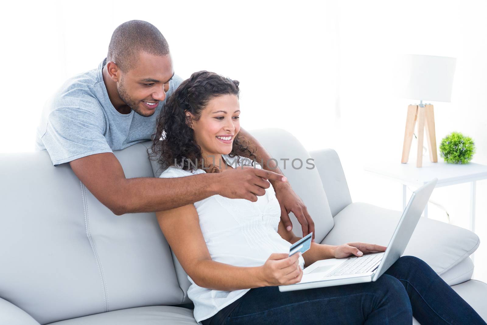 Couple shopping online on laptop at home