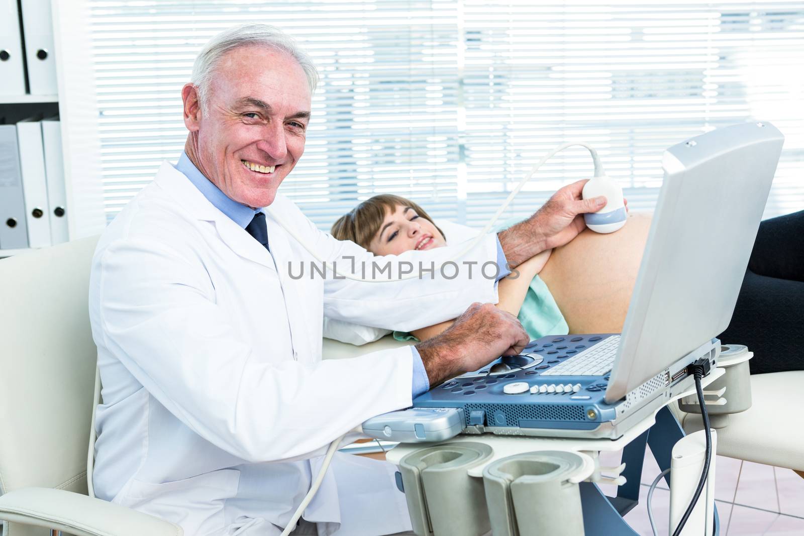 Male doctor doing ultrasound test by Wavebreakmedia