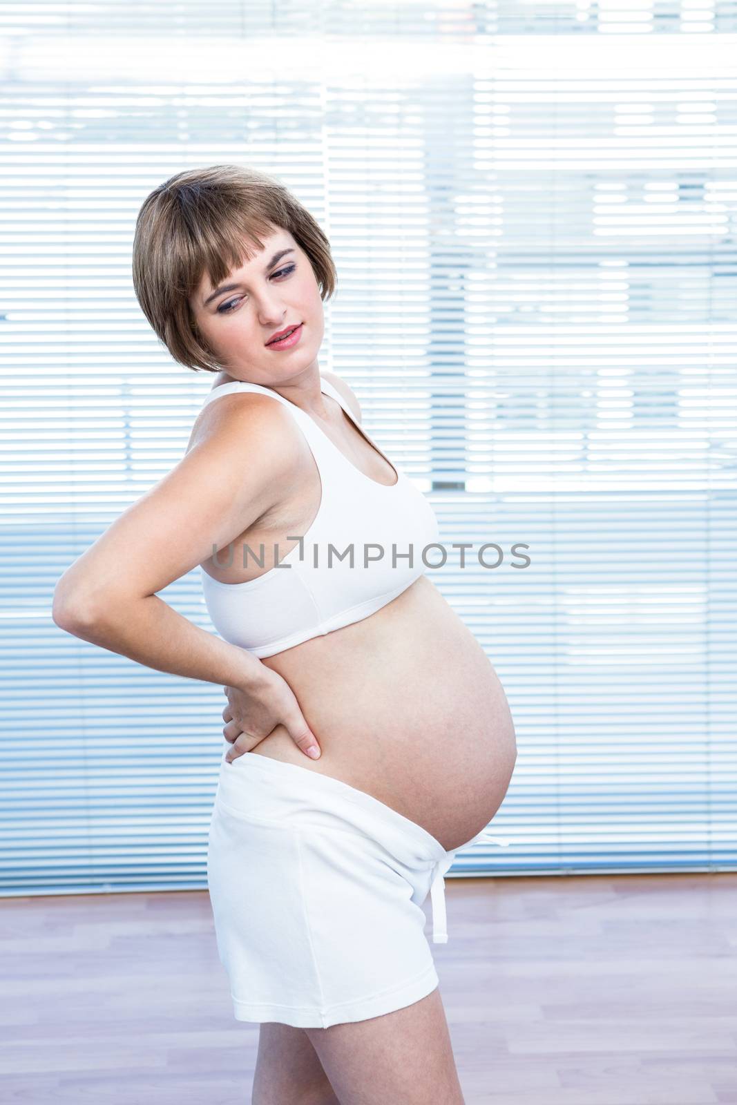 Pregnant woman practising in yoga studio