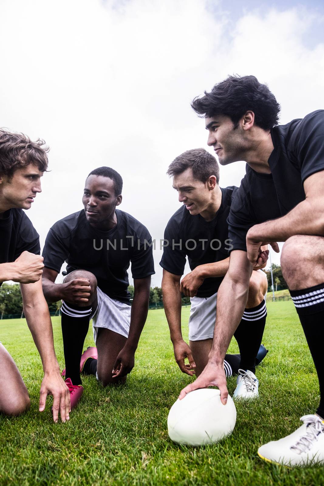 Rugby players discussing their tactics at the park