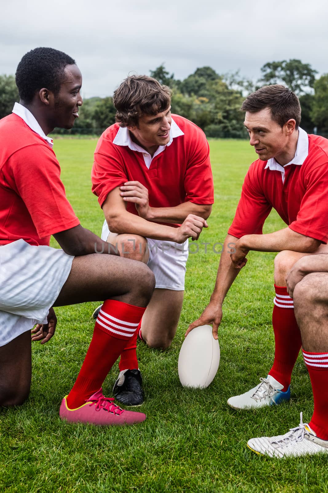 Rugby players discussing tactics before match at the park