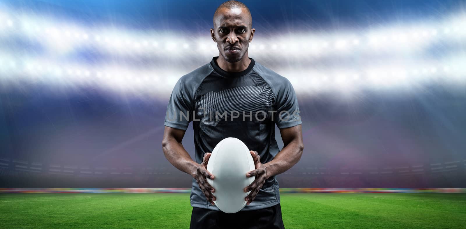 Composite image of portrait of serious athlete holding rugby ball by Wavebreakmedia