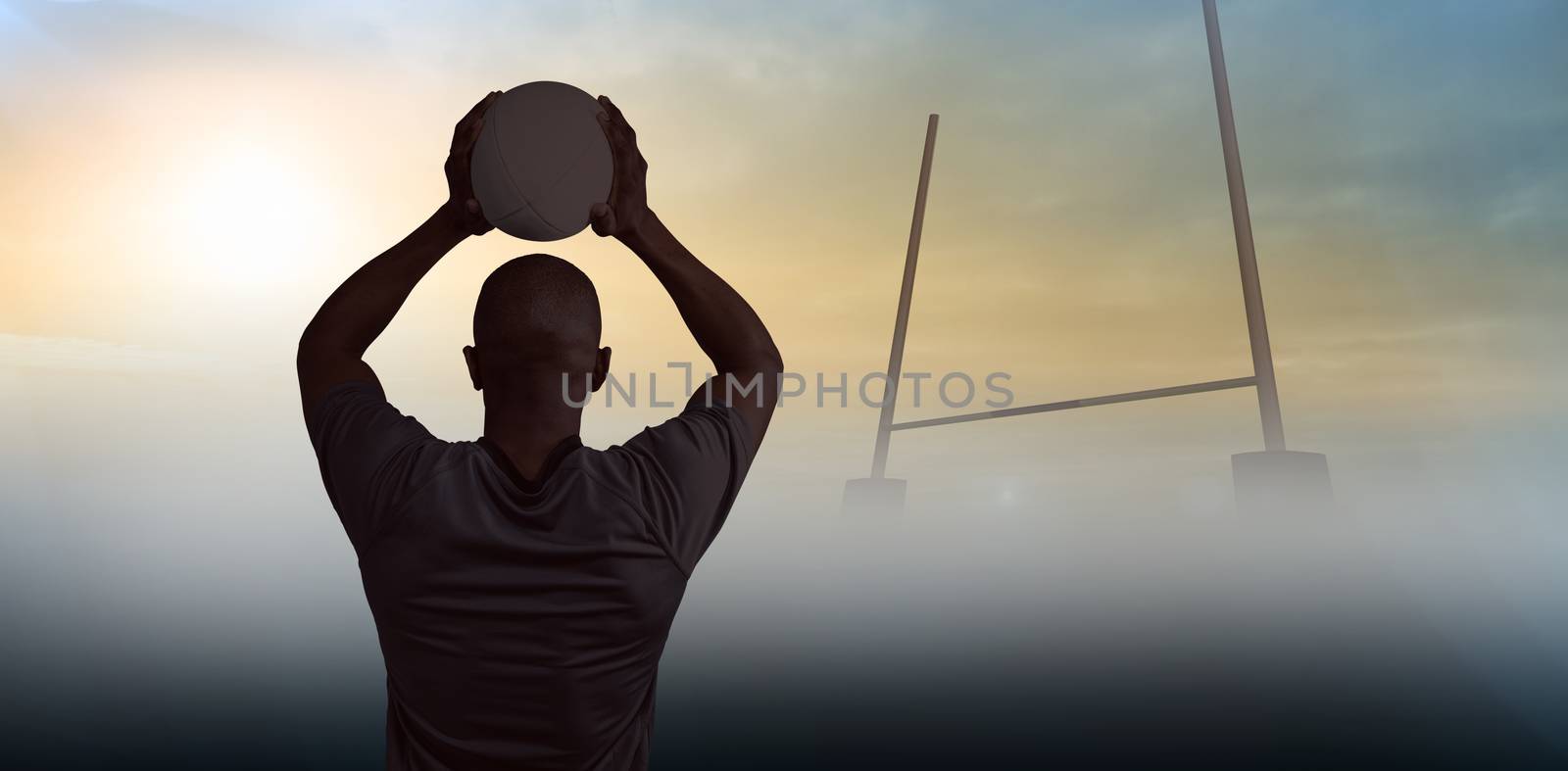 Composite image of rear view of athlete throwing rugby ball by Wavebreakmedia