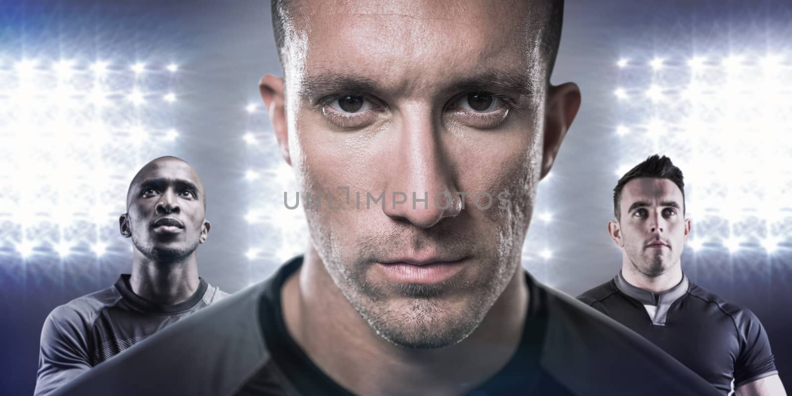 Close-up portrait of serious rugby player against spotlight