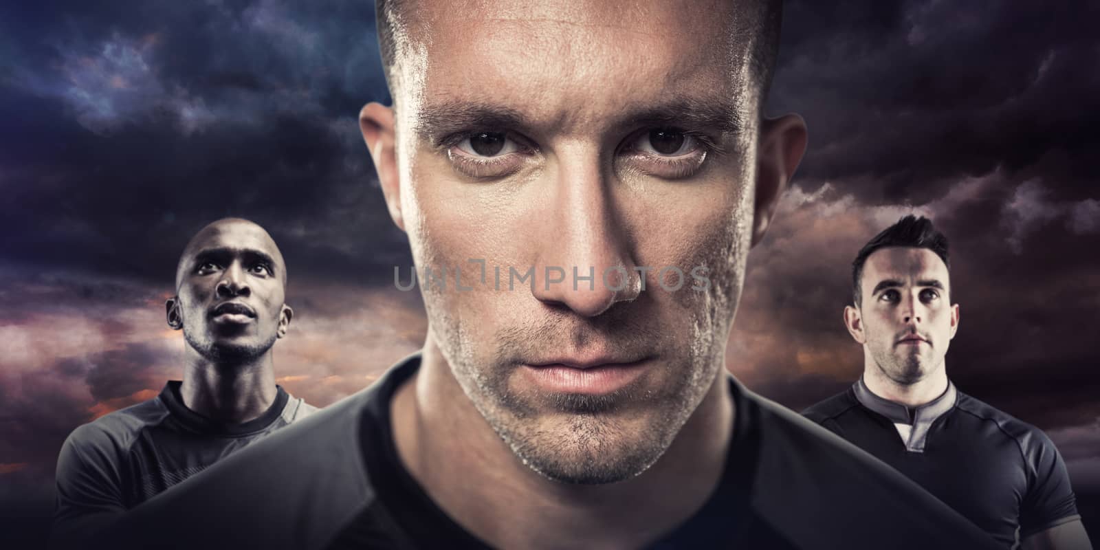 Close-up portrait of serious rugby player against blue and orange sky with clouds