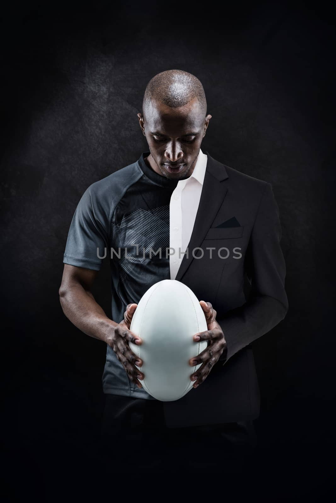 Composite image of thoughtful athlete looking at rugby ball by Wavebreakmedia
