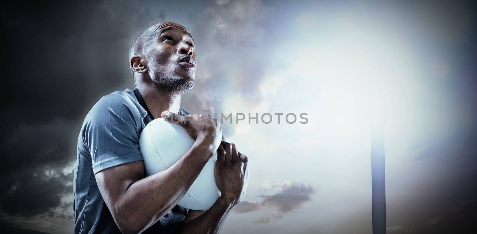Composite image of rugby player catching ball while playing by Wavebreakmedia