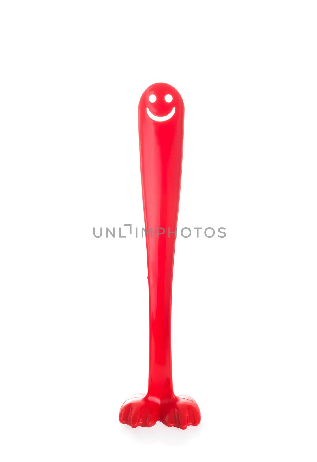 Red plastic shoehorn or shoespoon with a smiling face like a big long penis isolated on white background, the concept of an erection, potency, sexual health