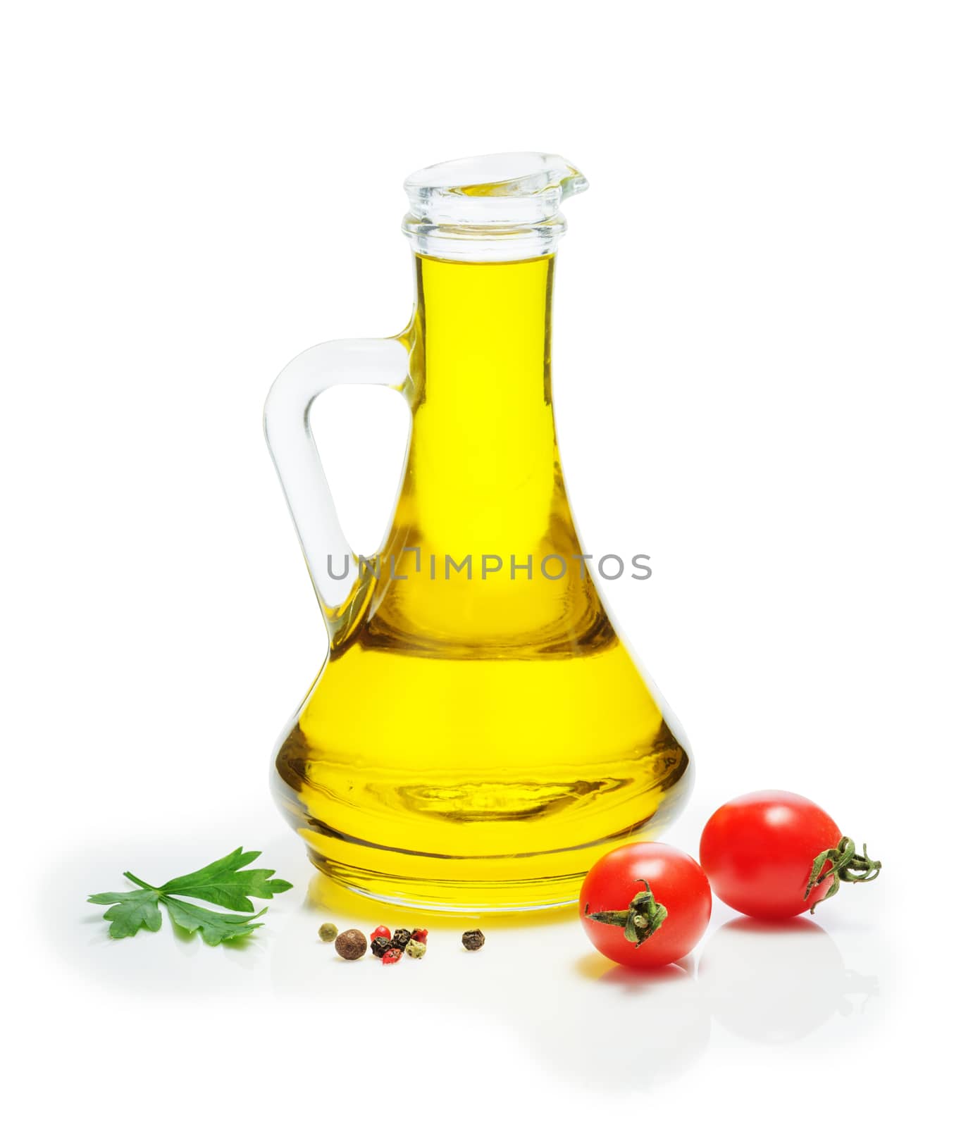 Olive oil in a glass jug, cherry tomatoes, a mixture of peppers, on a white background. Spices, herbs, vegetable oil.