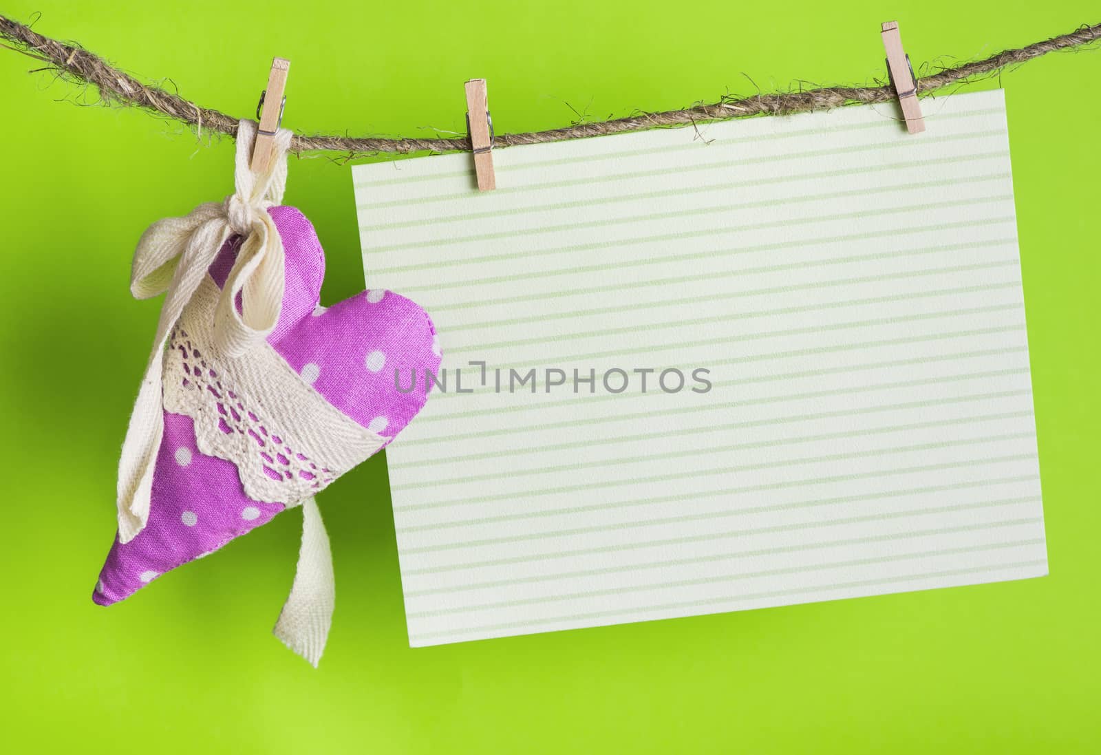  message card with handmade heart of the cloth with polka dots on a rope with clothespins, greeting and love concept,  happy birthday, Congratulations on March 8
