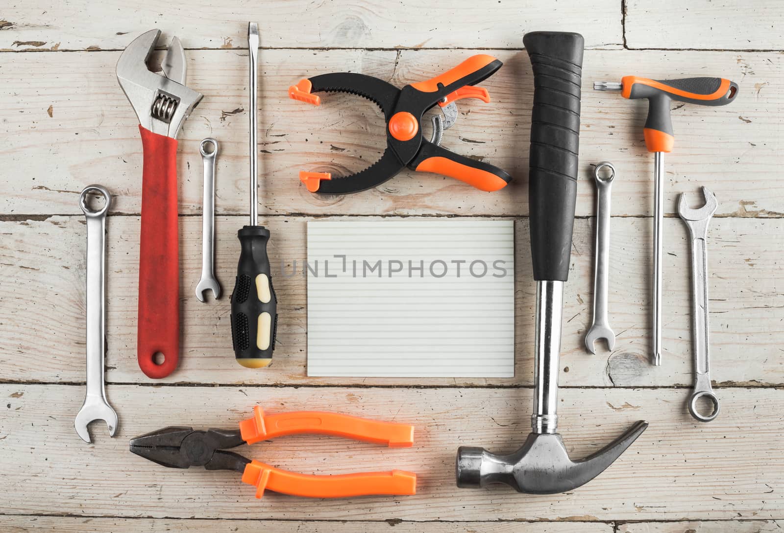 Greeting Card to Happy Father's Day, Happy Birthday Dad, concept, set of different tools: a hammer, wrench, screwdriver, various spanners, clamp on a wooden background