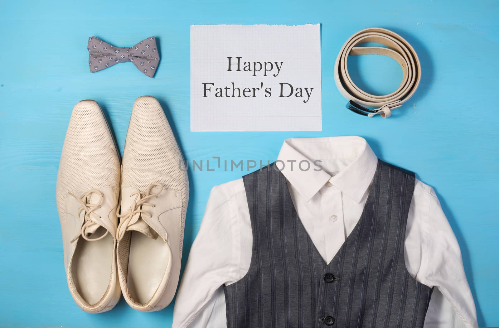 a white shirt,  men's shoes, gray vest and bow tie, a belt and a sheet of paper with text Happy Father's Day, Greeting concept, festive, holiday, congratulate a man Happy Birthday
