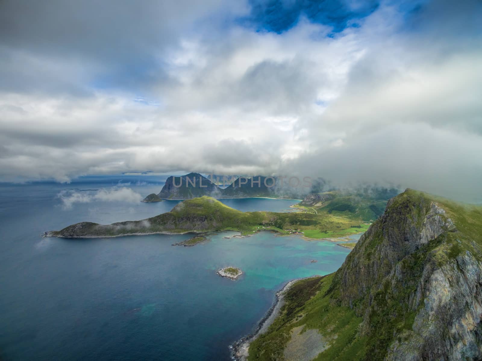 Low clouds above magnificent cliffs on Lofoten islands in Norway