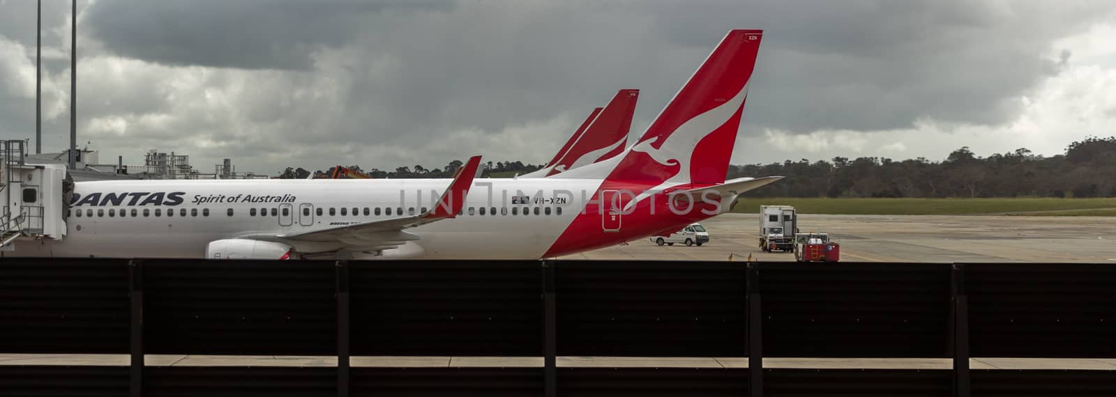 MELBOURNE/AUSTRALIA - SEPTEMBER 22, 2015: Heavy Jetliners parked at passenger terminal taking on passengers