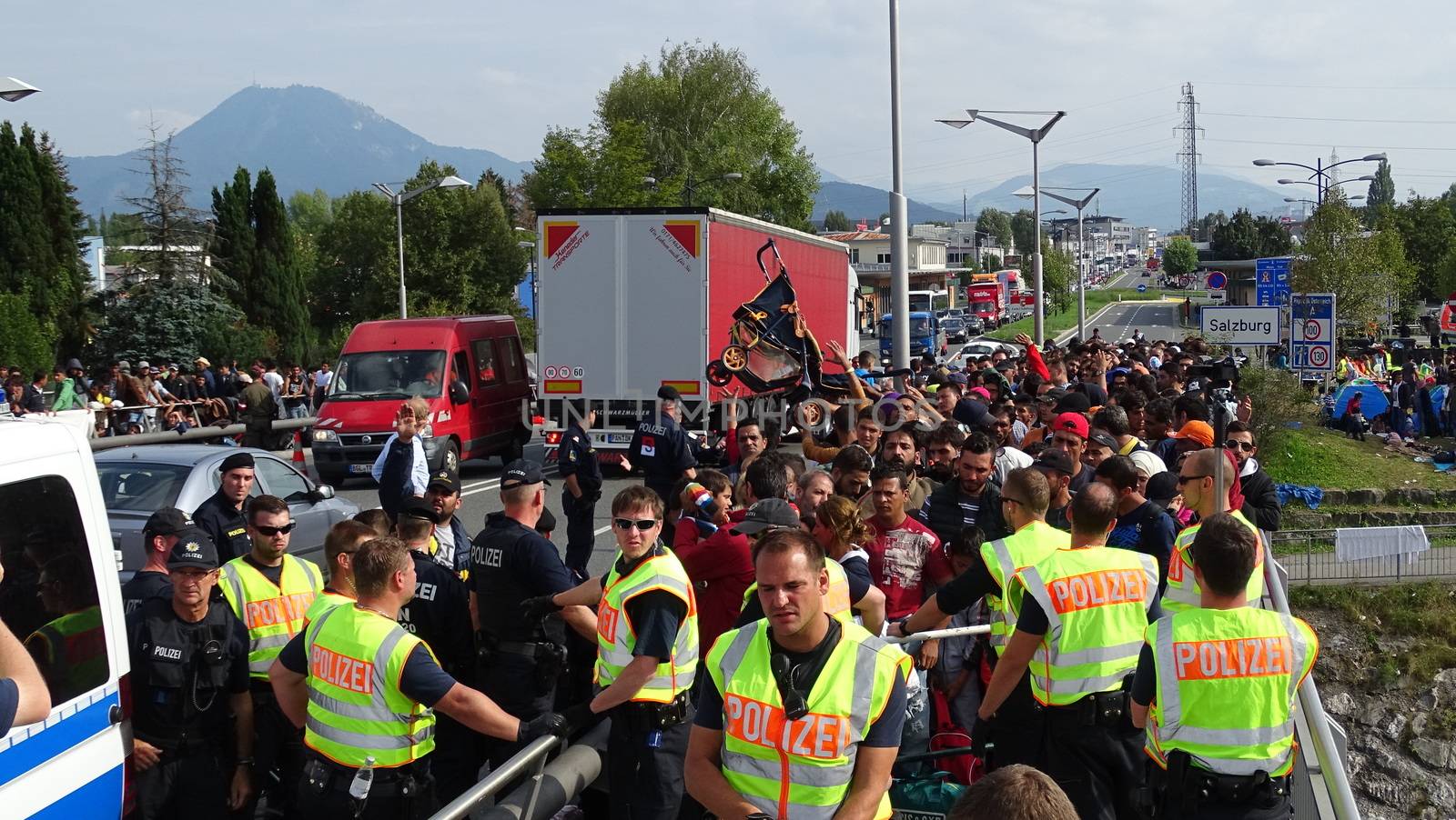 AUSTRIA, Salzburg: Scores line up at the border control in Salzburg, Austria on September 22, 2015 amid an ongoing refugee crisis, which has seen thousands flee from Syria and other war-torn countries for safety in Europe.