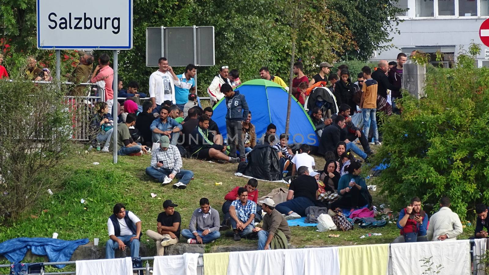AUSTRIA, Salzburg: Scores line up at the border control in Salzburg, Austria on September 22, 2015 amid an ongoing refugee crisis, which has seen thousands flee from Syria and other war-torn countries for safety in Europe.