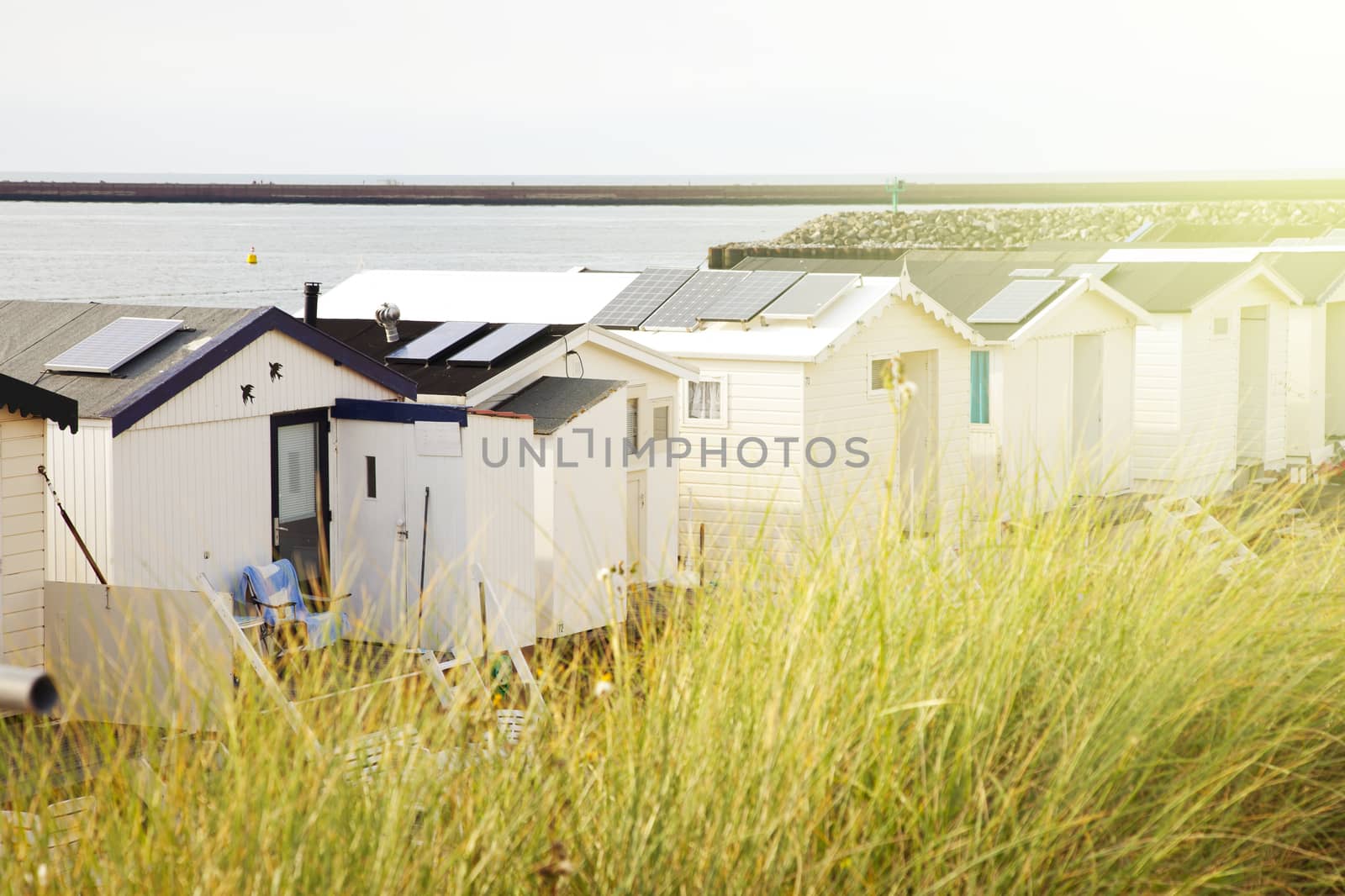 Row of Dutch beach houses with warm sun effect