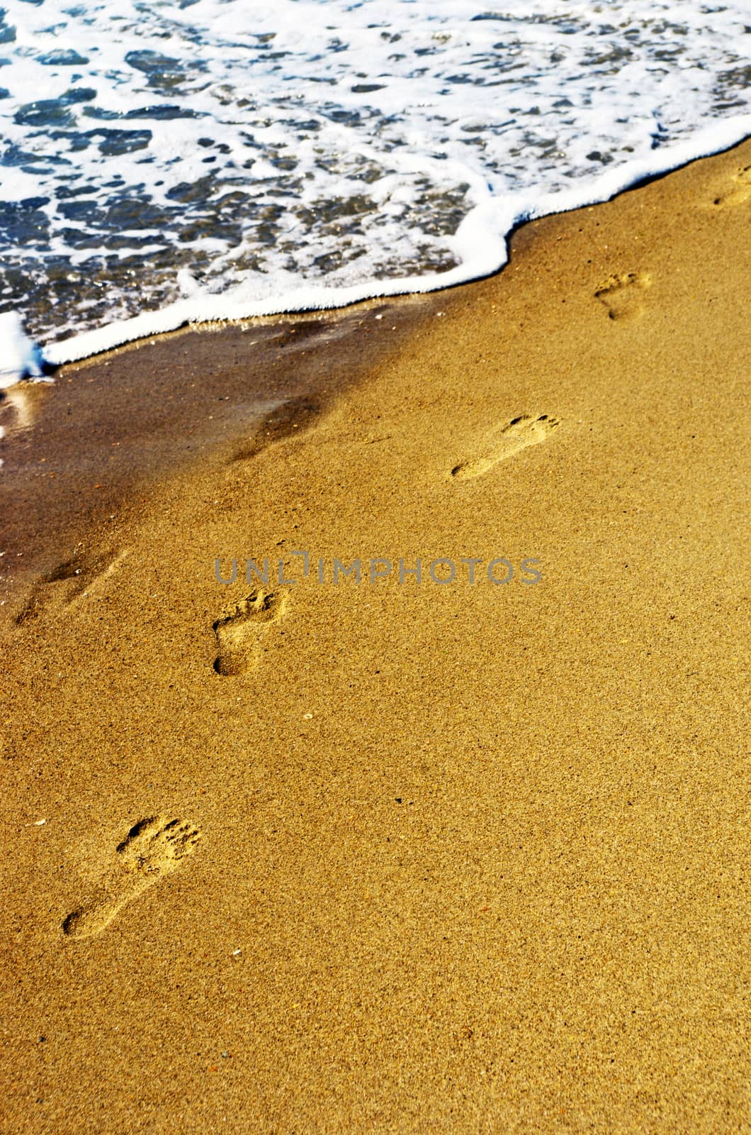 human prints on the beach. by dolnikow