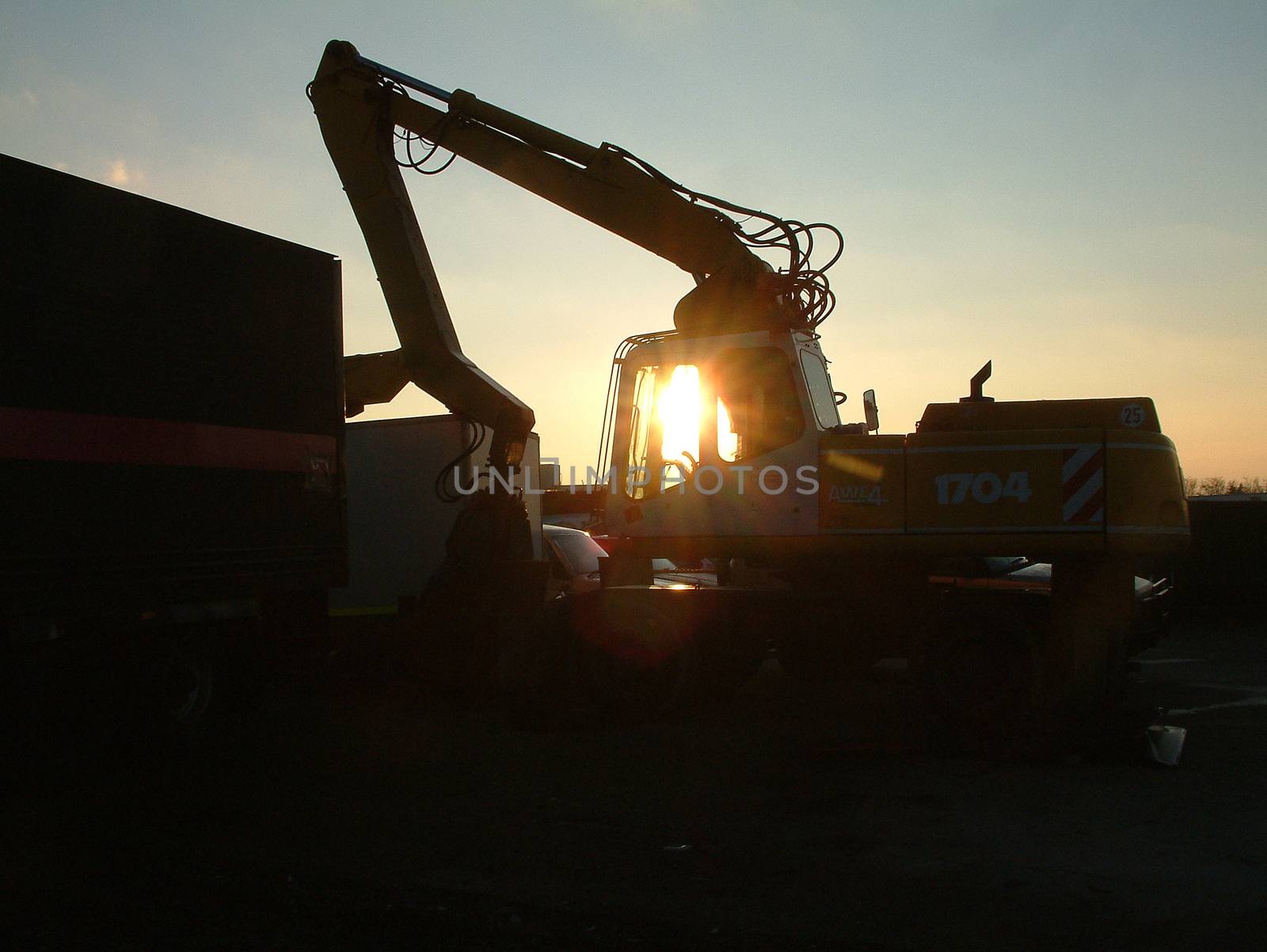 A typical scrap yard machine at sunset