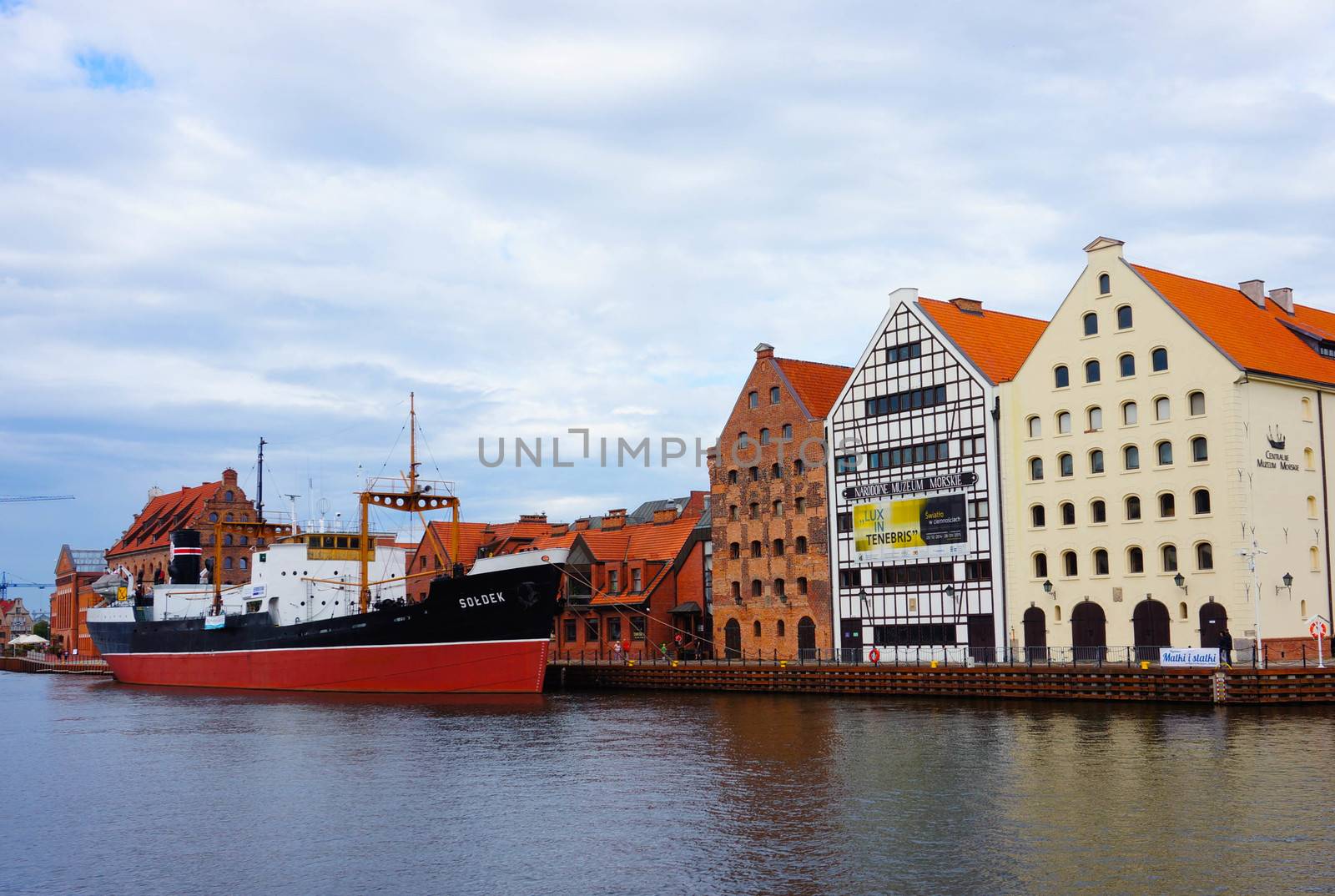 GDANSK, POLAND - JULY 29, 2015: Row of buildings by the Motlawa river with ship