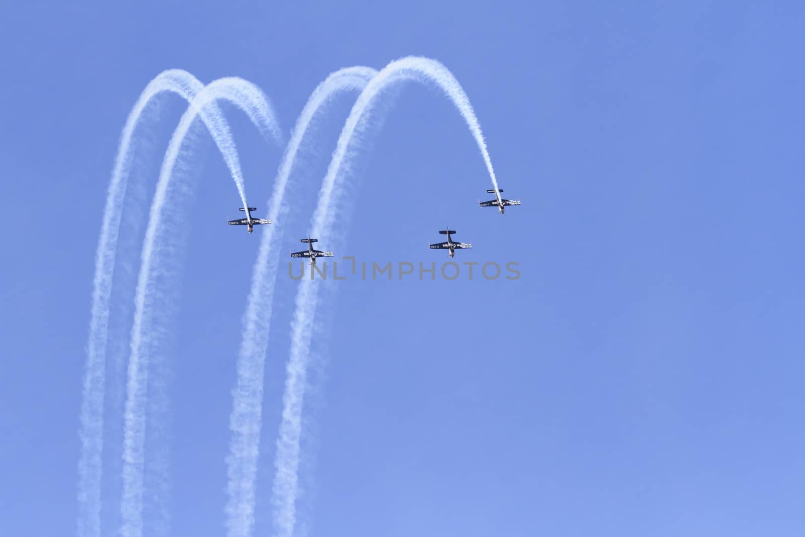 ENGLAND, Southport: Planes fly in formation leaving smoke trails during the Southport Airshow 2015 in Southport, Merseyside in England on September 19, 2015