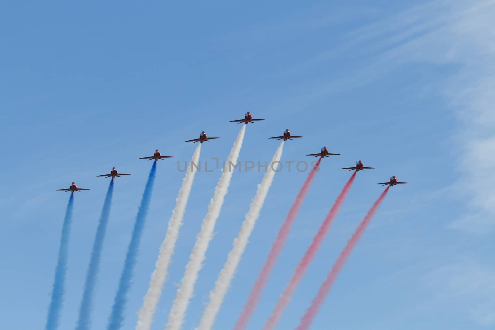 ENGLAND, Southport: Red Arrows fly in formation leaving coloured smoke trails during the Southport Airshow 2015 in Southport, Merseyside in England on September 19, 2015