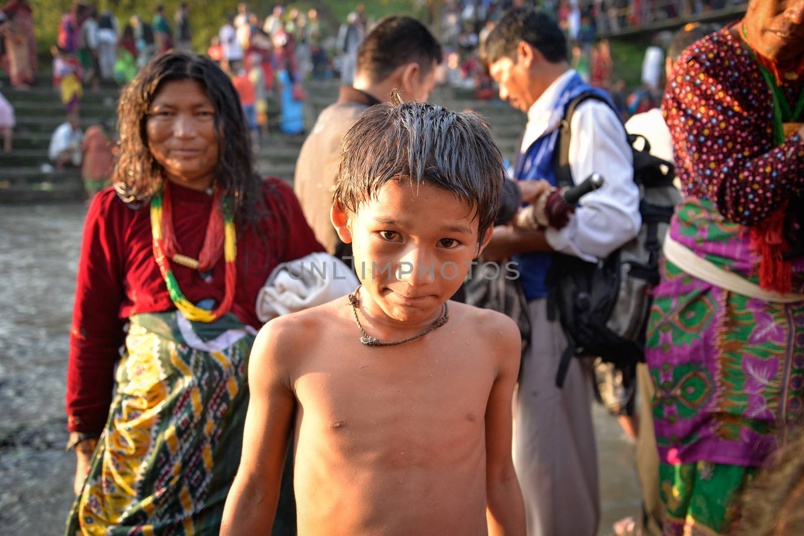 NEPAL, Nuwakot: Santosh Shrestha, a 10 year-old boy from Okharpauwa, Nuwakot District performs a religious ritual at Bagamti River Bank during Father's Day, on September 13, 2015.	Santosh's father passed away when he was six months old, and this was his fifth time performing the religious ritual at Gokarna, along with his grandfather, grandmother and his mother. He lives in poverty on a rubbish dump with his family, and is not able to go to school. 