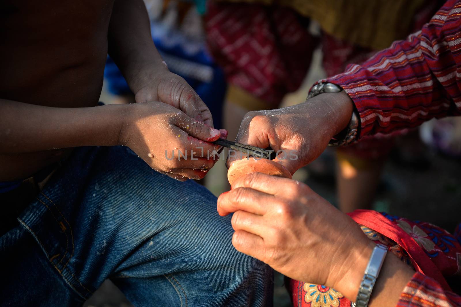 NEPAL, Nuwakot: Santosh Shrestha, a 10 year-old boy from Okharpauwa, Nuwakot District performs a religious ritual at Bagamti River Bank during Father's Day, on September 13, 2015.	Santosh's father passed away when he was six months old, and this was his fifth time performing the religious ritual at Gokarna, along with his grandfather, grandmother and his mother. He lives in poverty on a rubbish dump with his family, and is not able to go to school. 