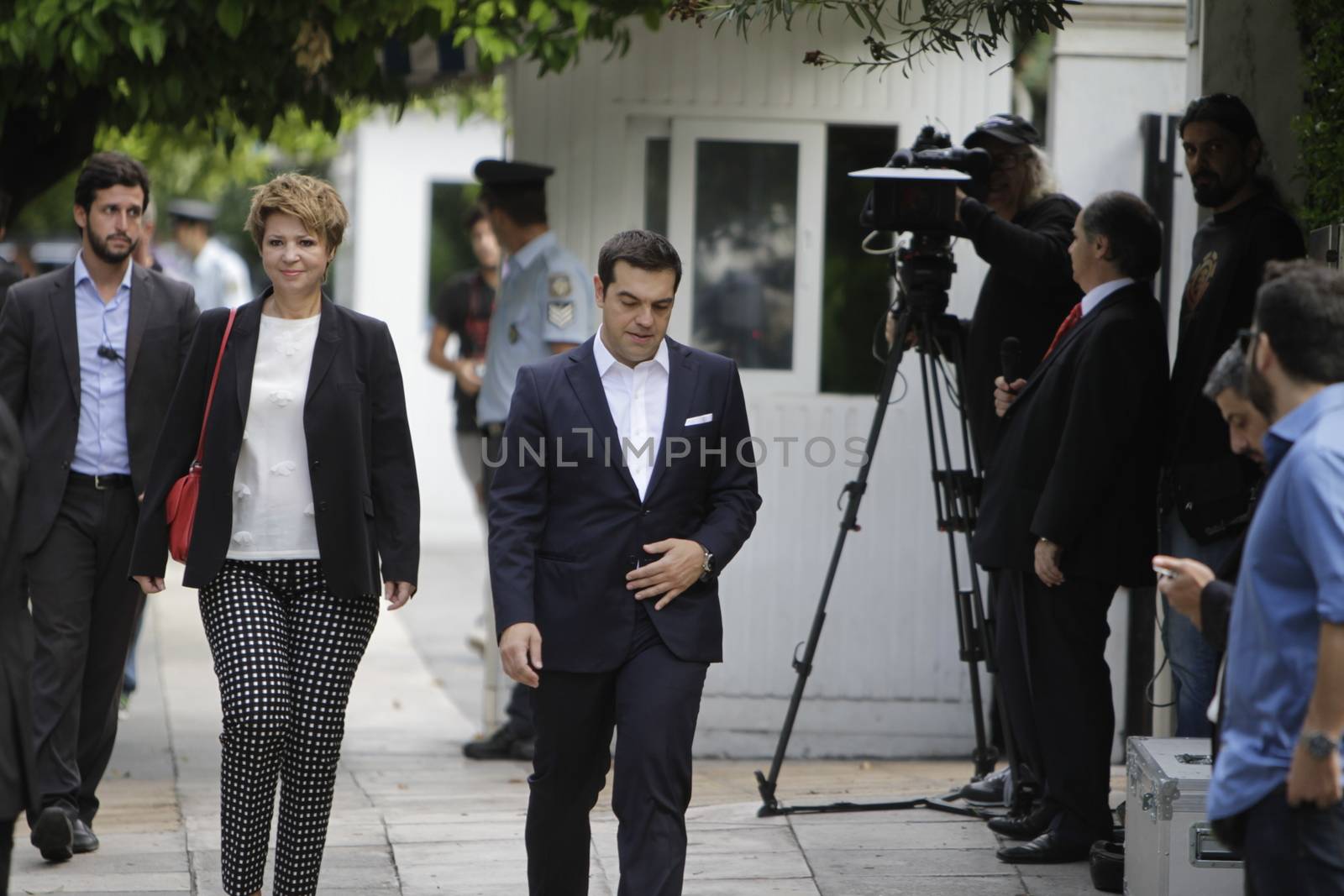 GREECE, Athens: Alexis Tsipras (right), the Prime Minister of Greece, and Olga Gerovasili (left), the designated government spokeswoman, arrive at the Presidential Mansion for the swearing-in ceremony in Athens, Greece on September 23, 2015. The ceremony took place at the Presidential Mansion, three days after the victory of SYRIZA (Coalition of the Radical Left) in the second Greek General Election in eight months.The implementation of the bailout, agreed after months of bitter negotiations, will be the government's overwhelming task.