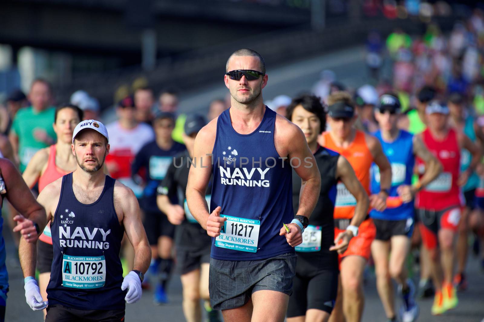 AUSTRALIA, Sydney: Members of the Australian Navy run as they take part in the Sydney Running Festival on September 20, 2015. Around 30,000 participants took part in the 15th Sydney Running Festival which incorporates a 42km marathon, a half marathon, a 9km bridge run as well as a 3.5km family fun run