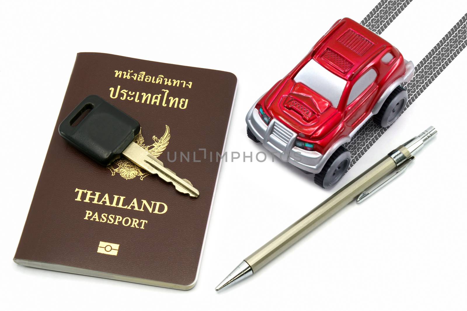 Thailand passport, key, pen and red 4wd car for travel concept.