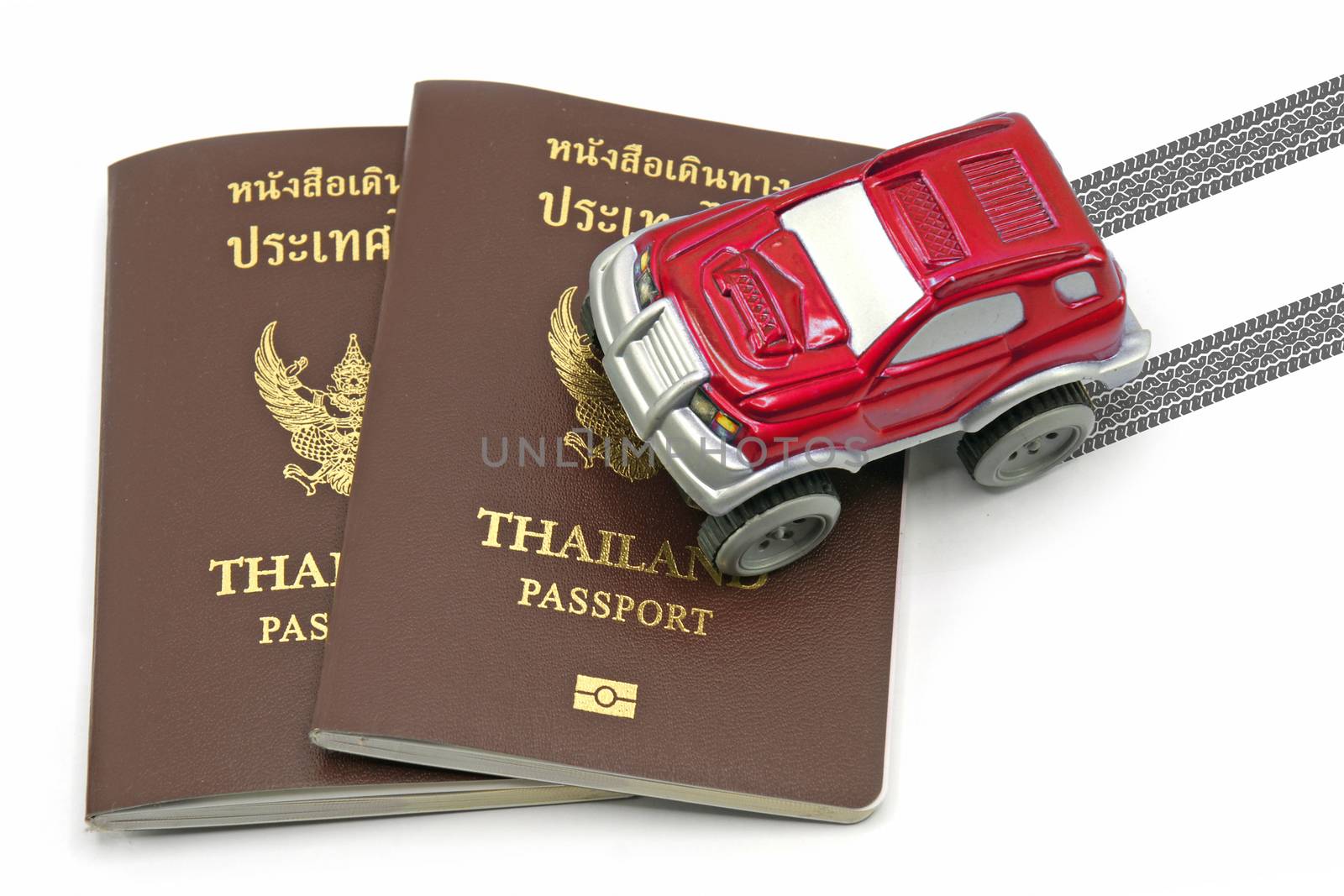 Thailand passport and red 4wd car for travel concept.