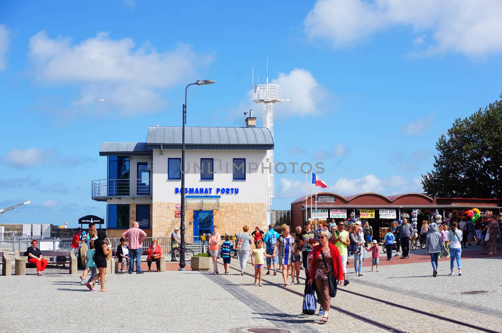 KOLOBRZEG, POLAND - JULY 23, 2015: Many people walking on the harbor on a sunny day