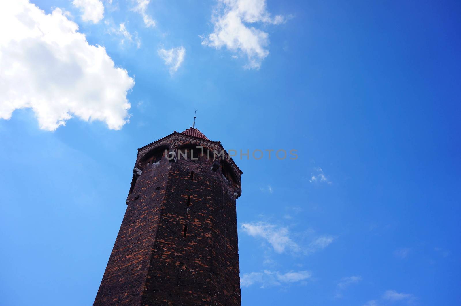 High stone tower and blue sky 