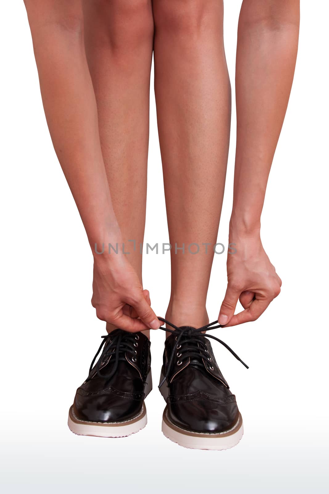 woman tie shoelaces on brogue shoes isolated