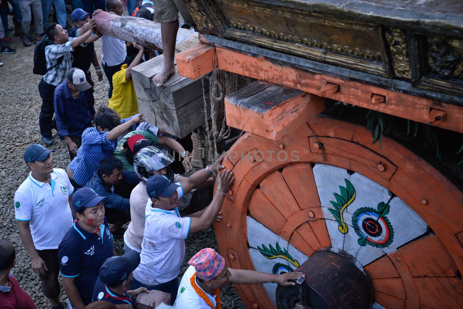 NEPAL, Patan: Hindus and Buddhists gather around the chariot of Rato Machhindranath as it is pulled along a river in Patan, Lalitpur, Nepal, on September 23, 2015. 