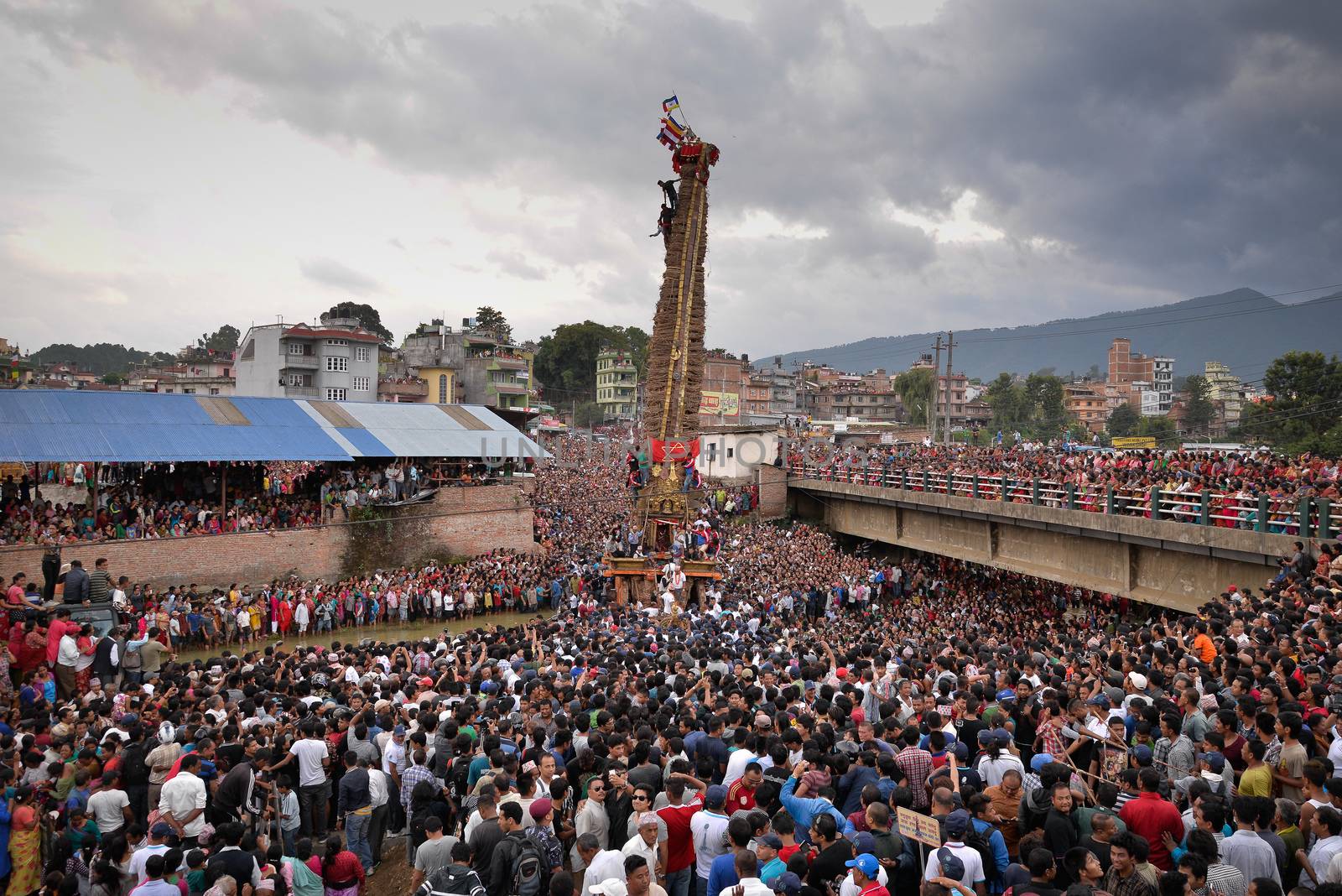NEPAL, Patan: Hindus and Buddhists gather around the chariot of Rato Machhindranath as it is pulled along a river in Patan, Lalitpur, Nepal, on September 23, 2015. 