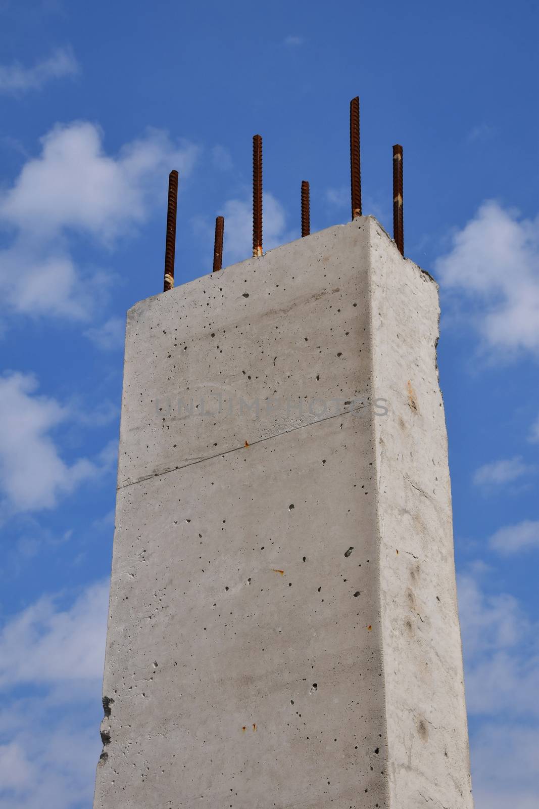 Reinforced concrete pillar against cloudy blue sky by BreakingTheWalls