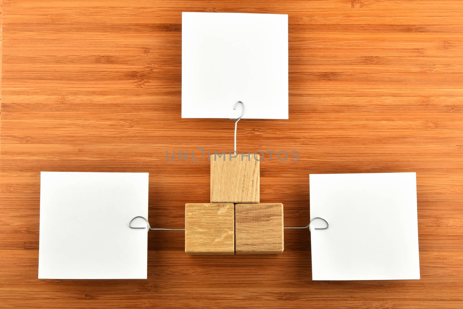 Three paper notes with holders in different directions on wood by BreakingTheWalls